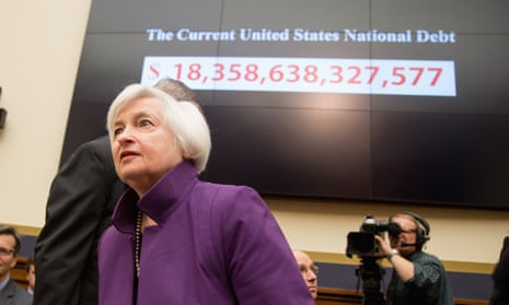 Federal Reserve chair Janet Yellen passes a national debt banner as she arrives on Capitol Hill in Washington on Wednesday.
