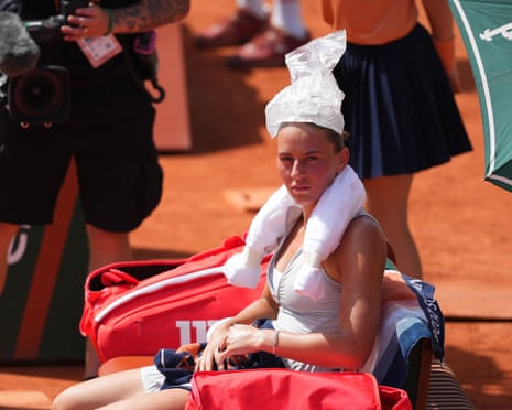 Kostyuk tries to cool off by resting ice on her head