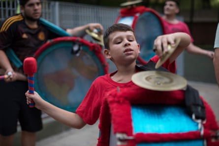 Ten-year-old Felipe practices the drums with cymbals, during a rehearsal in a local park in the lead up to carnival season in Boedo.