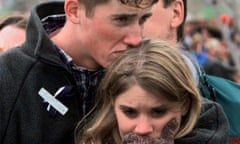 In this 25 April 1999 photo, Austin Eubanks hugs his girlfriend during a memorial service for Columbine high school shooting victims.