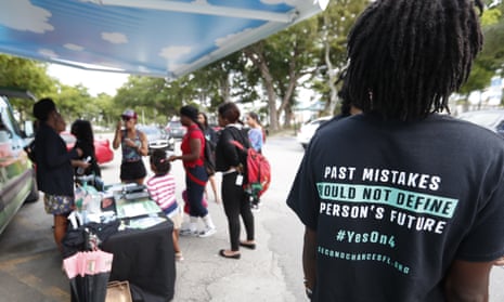 People gather around the Ben &amp; Jerry’s ‘Yes on 4’ truck as they learn about Amendment 4, which asked voters to restore the voting rights of people with past felony convictions. 