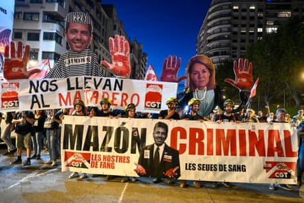 Demonstrators hold banners depicting the regional president, Carlos Mazón, and vice-president, Susana Camarero