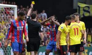Wilfried Zaha reacts to being shown the yellow card for simulation by referee Chris Kavanagh.