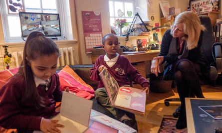 The headteacher of Avondale primary school near Grenfell Tower accompanies pupils as they look at memory books made to help them deal with grief.