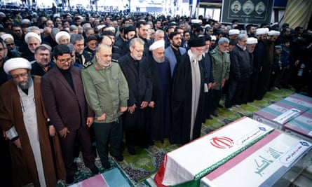 Iran’s supreme leader, Ayatollah Ali Khamenei, and President Hassan Rouhani pray near the coffins of Qassem Soleimani