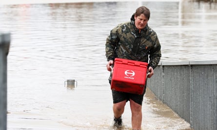 A man removes property from his business in Weza lane, Kumeu as heavy rain causes extensive flooding and destruction on August 31, 2021 in Auckland, New Zealand.