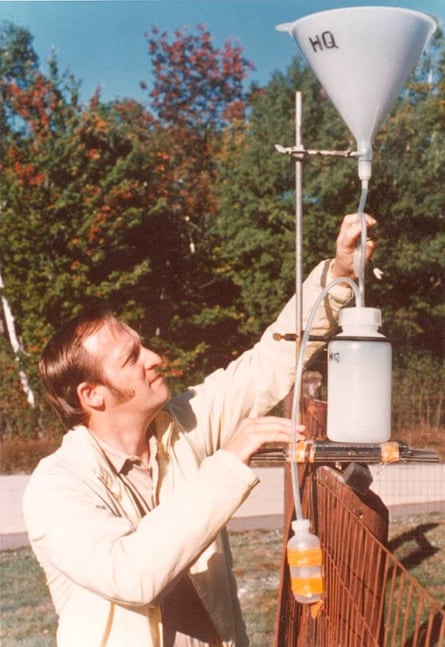 Gene Likens sets up a precipitation collector at Hubbard Brook in New Hampshire.
