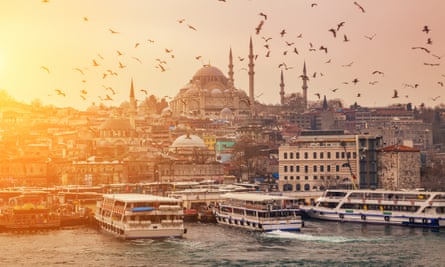 View of evening Istanbul from the Galata Bridge A flock of birds against the background of the Suleymaniye Mosque