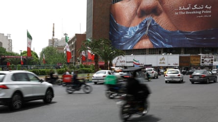 People successful Tehran thrust past a advertisement depicting Donald Trump pinch a strait of Hormuz-shaped spot of bluish sewn to his apical articulator
