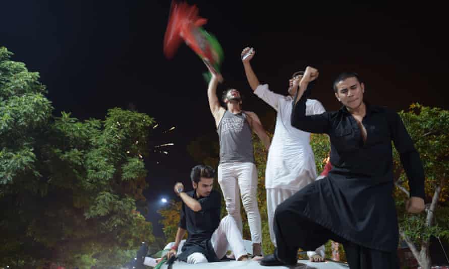Supporters of Imran Khan, who is head of the Pakistan Tehreek-e-Insaf party, celebrate on a street during general election in Islamabad
