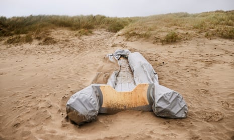 A damaged inflatable dinghy on Loon-Plage, France, from where Wednesday’s ill-fated vessel is believed to have left.