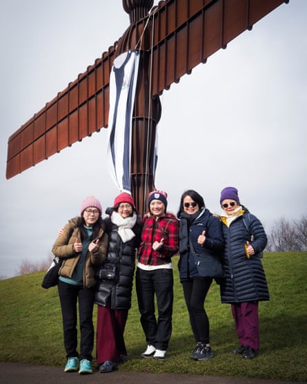 Five women in front of Angel of the North statue