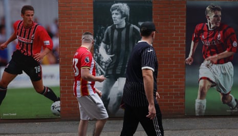 Fans walk past tributes to some Bournemouth legends outside the Vitality Stadium before today’s match between Bournemouth and Brentford