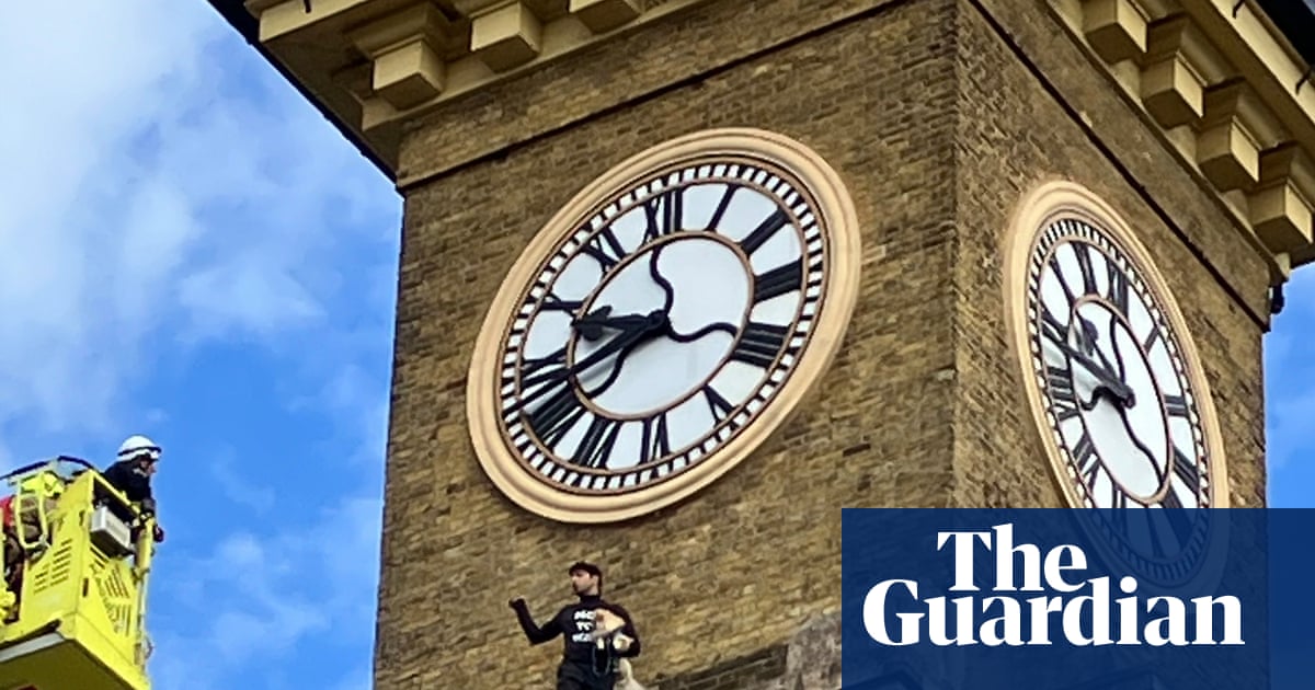 Man with dog unfurls Iran protest banner from King's Cross clock tower