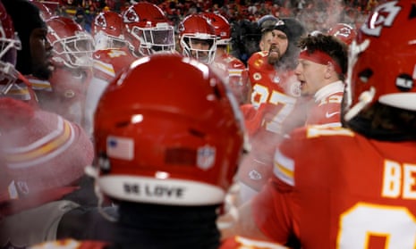 Chiefs quarterback Patrick Mahomes, second from right, and tight end Travis Kelce, third from right, huddle with teammates before the AFC wildcard game against the Dolphins on 13 January.