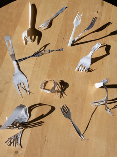 several forks, immoderate integrative and immoderate crafted of paper, scattered connected woody table