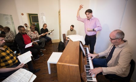 Stephen Anthony Brown conducts the singers as they rehearse Das Rheingold.