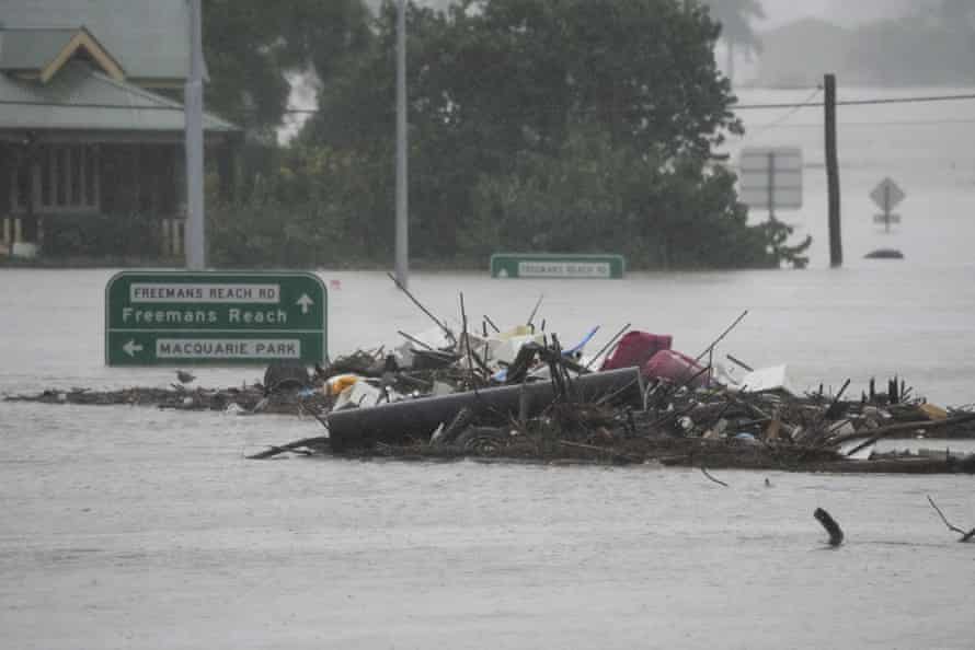 Debris sits in the middle of the flooded Windsor bridge on the outskirts of Sydney on Monday.