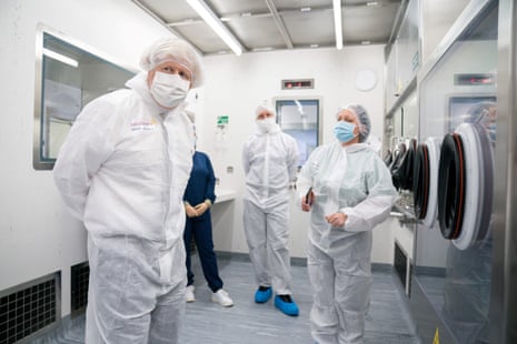UK prime minister Boris Johnson (L) gestures during a visit to AstraZeneca in Macclesfield, Chesire, northwest England on April 6, 2021, to learn more about their $500m (£360m) investment into the Macclesfield site.