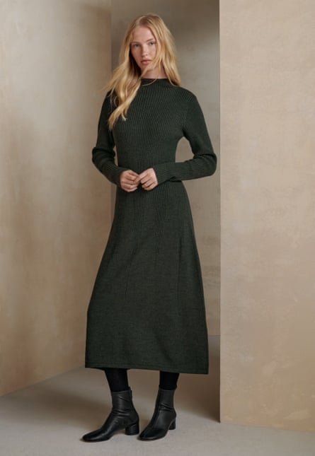 Model wearing a forest green knitted dress.