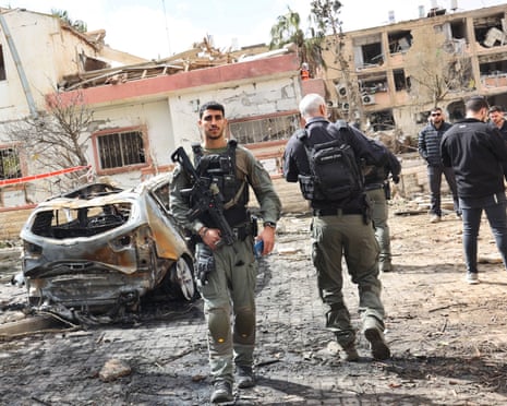 Security forces and rescue teams search the scene of Iranian strike in Dimona, Israel