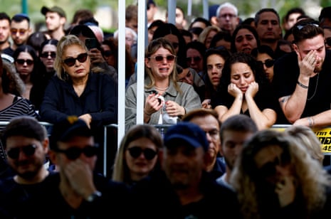 People mourn at Kiryat Shaul cemetery in Tel Aviv during the funeral for an Israeli reserve soldier who was killed during ground operations inside the Gaza Strip.