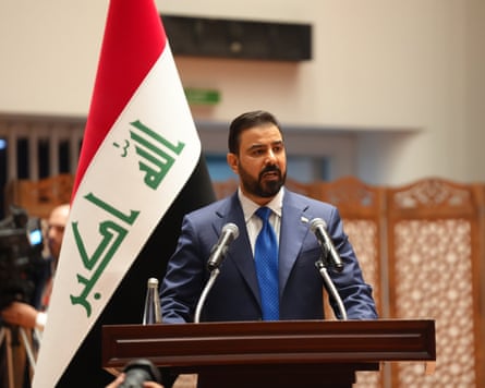 Ali al-Zaidi speaking in parliament on his inauguration day on 14 May next to an Iraqi flag