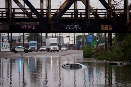 Cars are submerged on a flooded street in Long Beach, California, on Thursday.