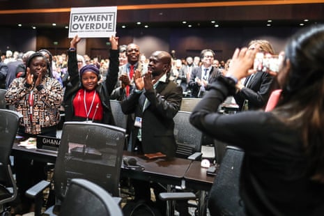 Nakeeyat Sam Dramani, a young poet from Ghana, holds a placard after giving a speech about global warming during the conference.