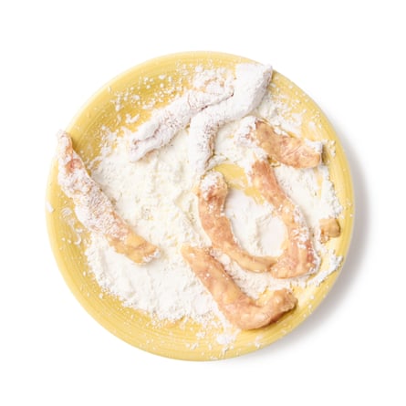 dunk the pork in the batter, then shake off any excess and roll it in the plate of cornflour to coat.