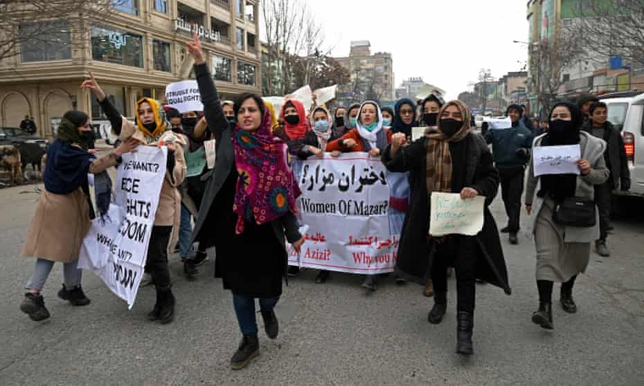 Afghan women chant slogans and hold banners during a women's rights protest in Kabul on Sunday.