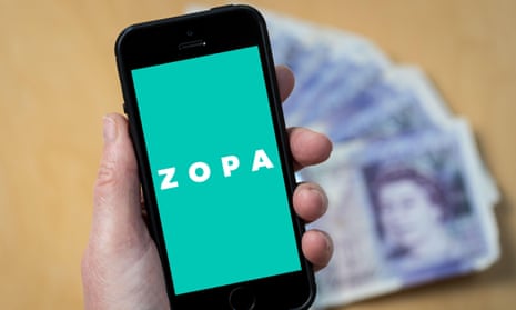 A woman looking at the Zopa logo on a mobile phone