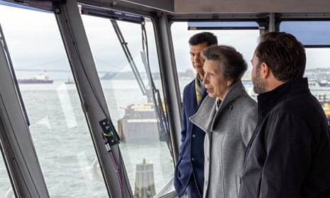 Princess Anne, with the New York City transport commissioner Ydanis Rodriguez, left, rides in the pilothouse of the Staten Island Ferry on Tuesday.