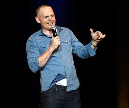 A man performs on stage with a microphone