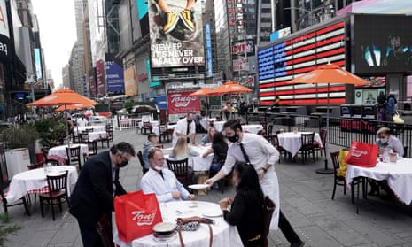 Servers deliver food to a table at a pop-up restaurant set up in Times Square, New York, in October.