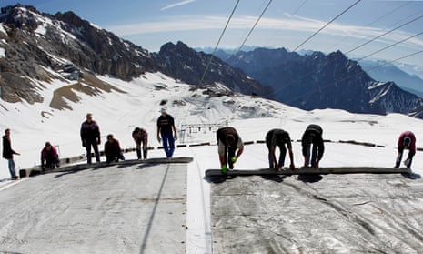 Workers cover a glacier with plastic sheets on the peak of Zugspitze mountain in Germany, May 2011.