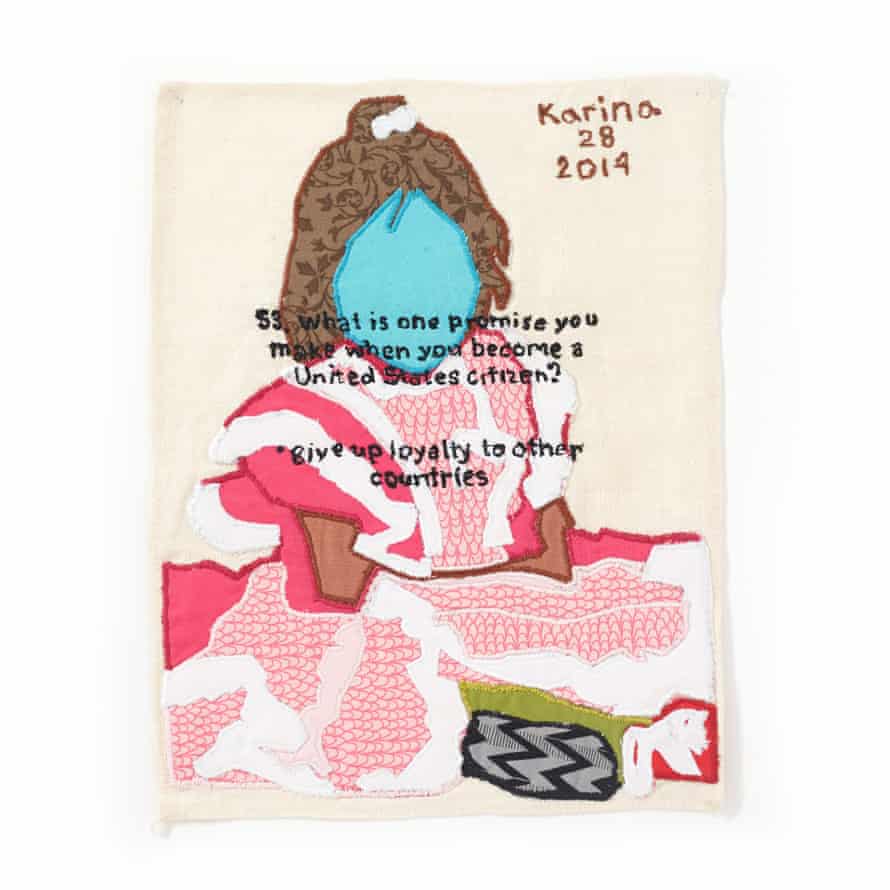 A fabric image of a faceless woman in a pink ruffled dress is stitched onto a rectangle of white. Stitched on the upper right corner is 'Karina, 28, 2014' and across the image: '53. What is one promise you make when you become a United States citizen? - give up loyalty to other countries'