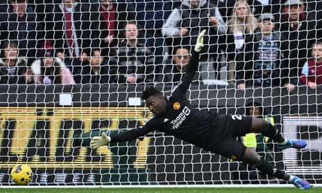 Manchester United’s keeper Andre Onana dives but cannot stop a shot from West Ham United’s Mohammed Kudus making it 2-0.