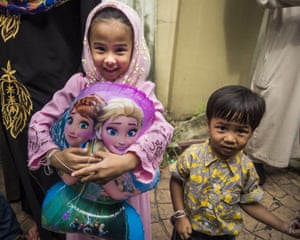 Bangkok, Thailand
A girl holds her Disney Frozen balloon as she leaves Ton Son Mosque