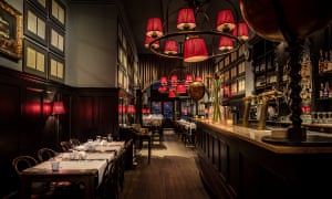 Dimly-lit interior of Café Restaurant Van Puffelen in Amsterdam, the Netherlands.