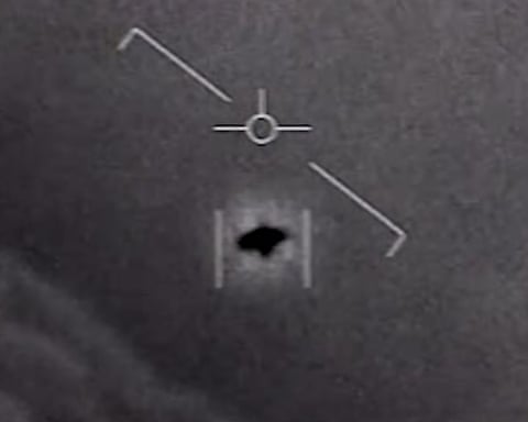 a blurry black and white image of a black floating object