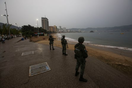 Soldiers keep watch at a beach as Hurricane Otis barrels towards Acapulco, Mexico