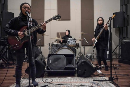Voice of Baceprot playing in a Jakarta practice room in 2021: from left, guitarist and vocalist Firda Marsya Kurnia, drummer Euis Siti Aisyah and bassist Widi Rahmawati.