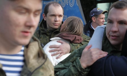 Conscripted men say goodbye to relatives at a recruiting office in Moscow on Wednesday.