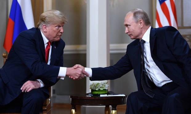 Vladimir Putin and Donald Trump shake hands in Helsinki in 2018.