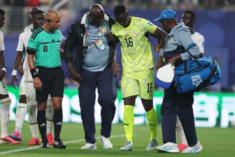 Mendy is helped off the pitch.