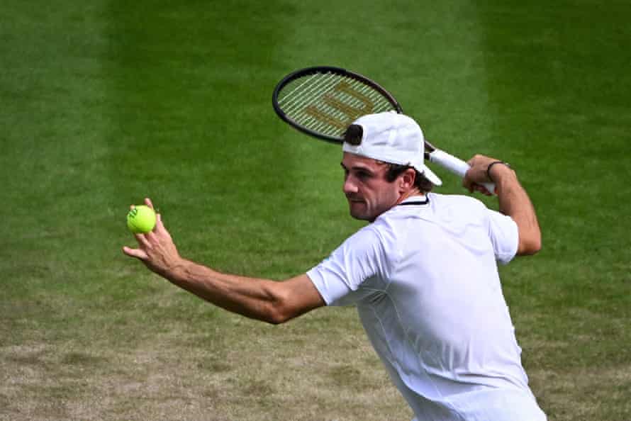 Tommy Paul eyes the ball as he returns it to Cameron Norrie.