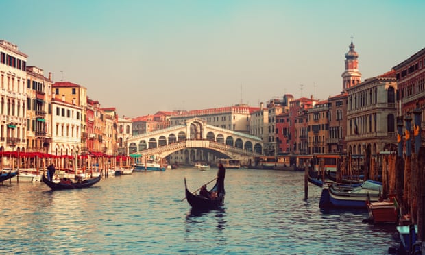Rialto Bridge, Venice, with gondolas in view.