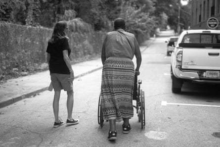 Two women walk down a street