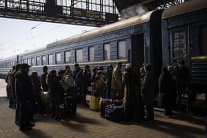 Ukrainians escaping from the besieged city of Mariupol along with other passengers from Zaporizhzhia gather on a train station platform after arriving at Lviv, western Ukraine, on Sunday